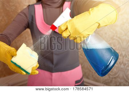 Female hands in gloves work with cleaning agent