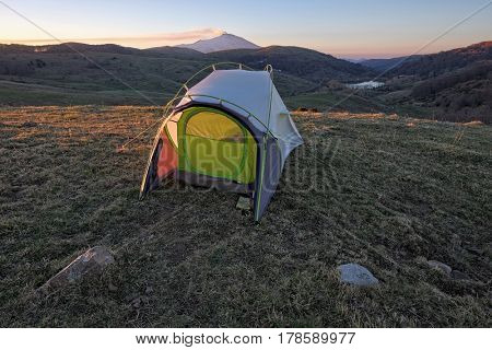 tent against Etna mount and Cartolari lake at sunrise in Nebrodi Park, Sicily 