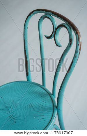 Vintage dirty wooden green elegant chair on a white floor