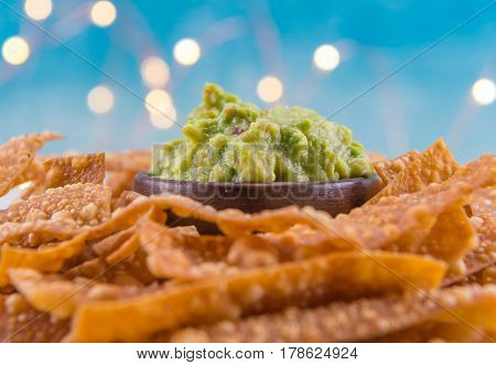 Selective Focus On Bowl Of Guacamole On Bed Of Homemade Chips