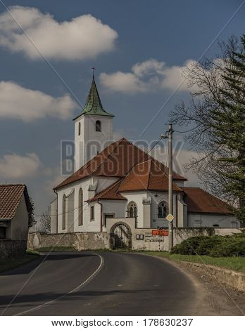 Church In Valtirov Village Near Main Road In Spring Sunny Day