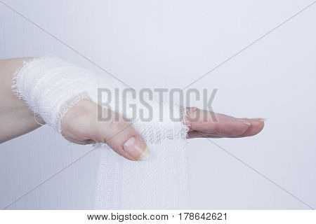 White medical dressing on a traumatized female hand