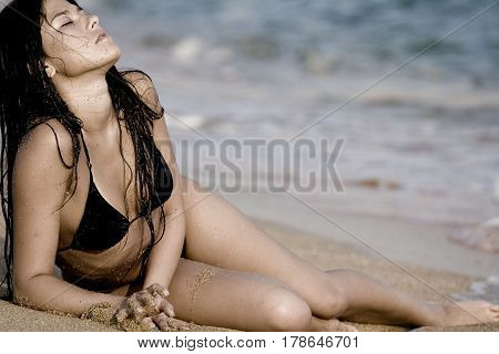 The girl lying on the sand at the beach