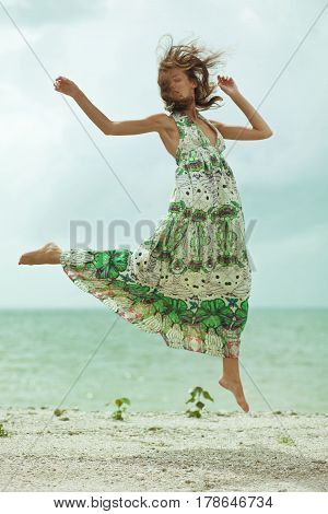 beauty happy girl jumping on the beach
