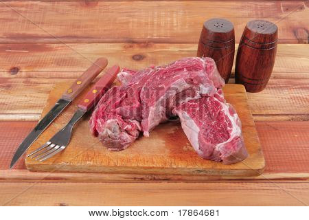 savory: fresh uncooked beef fillet mignon on board prepared for cooking on wood