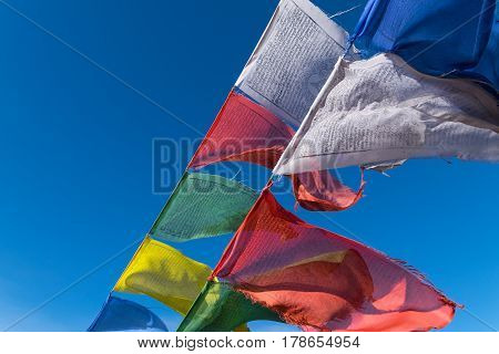 Buddhist Prayer Flags with blue sky on background in India