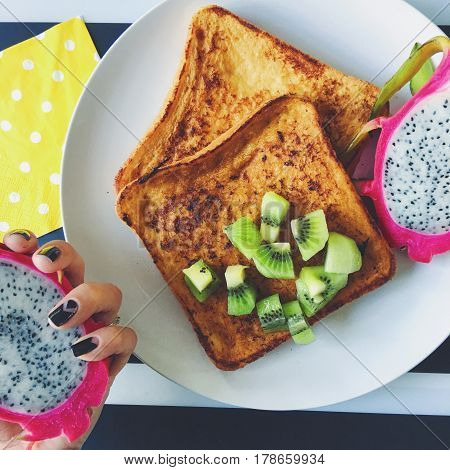 French toast breakfast with fruits - kiwi and dragon fruit also known as pittaya