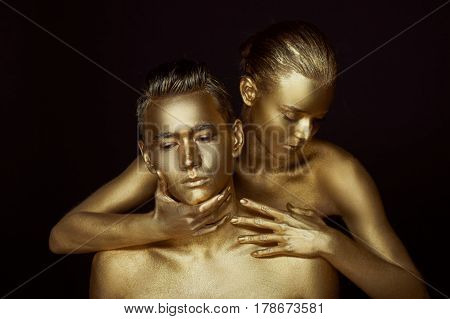 A girl and a boy, covered in gold paint. With my eyes closed. She bent down to him. Look in different directions. The fragmentation of interests