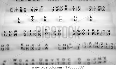 Stress letters between other blurred lettters, black and white.