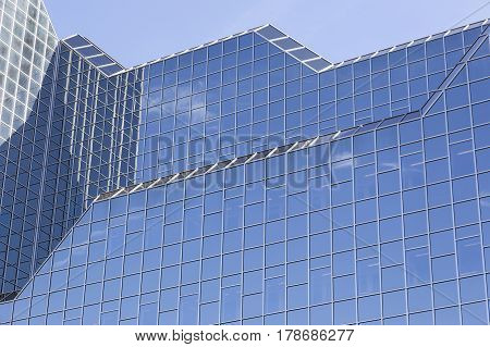 utrecht Netherlands 15march 2017: glass facade of rabobank head office in dutch town reflects clouds and blue sky