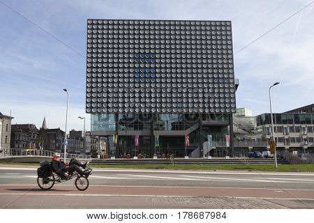 Utrecht Netherlands 15 march 2017: man on recumbent bicycle in front of Concert hall Tivoli Vredenburg in the Dutch town of Utrecht