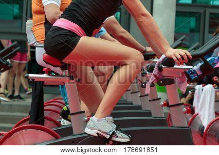 Group Of Boys And Girls At Gym: Workout With Spinning Bikes