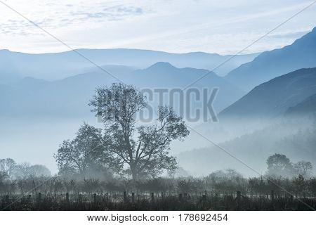 Stunning Winter Foggy Sunrise Over Countryside Around Crummock Water In Lake District England
