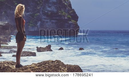 Girl on Tembeling Coastline at Nusa Penida island, Bali Indonesia.