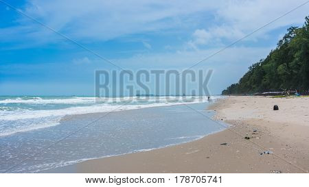 Unidentified person collecting rubbish along the beach in the moring at Mae Rumphueng Beach , Rayong , Thailand