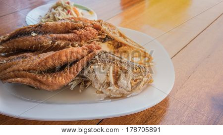 Crispy deep fried Sea bass with fish sauce and spicy raw mango salad
