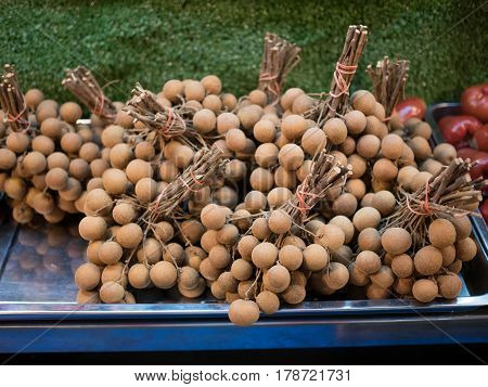 Photo of branches with fresh longan in shop