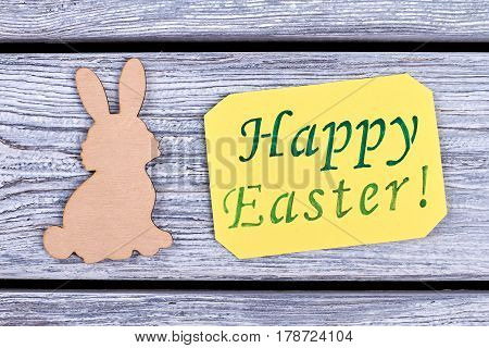Plywood Easter rabbit. Easter greeting card. Warm wishes for Easter holiday.