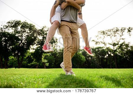 Close up photo of young beautiful couple rejoicing in park. Copy space.