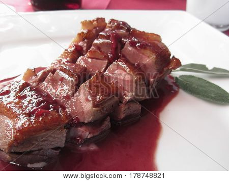 Duck breast on Sangiovese red wine sauce . Italian recipe
