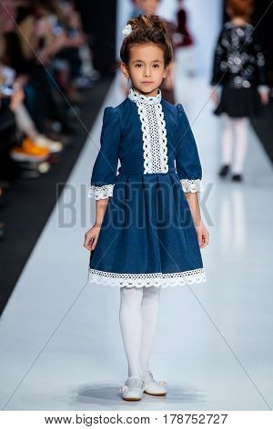MOSCOW RUSSIA - MARCH 15 2017: Model walk runway for ALISIA FIORI catwalk at Fall-Winter 2017-2018 at Mercedes-Benz Fashion Week Russia. Kid's fashion. Fashion Time Designers.