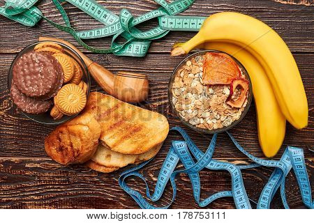 Measuring tapes, fruits and sweets. Struggle to get healthy.