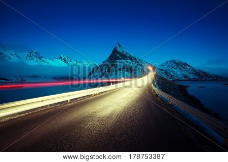 Olstind Mount and car light. Lofoten islands? spring time, Norway