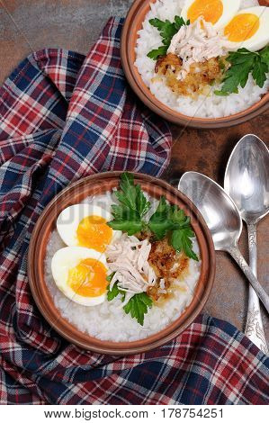 Rice porridge ginger congee with egg chicken crispy shallots and parsley
