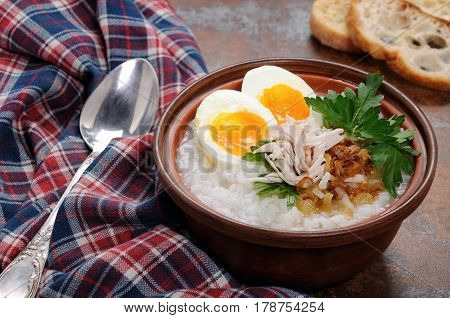 Rice porridge ginger congee with egg chicken crispy shallots and parsley
