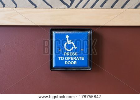 Handicapped Access Entrance Pad On A Wall.