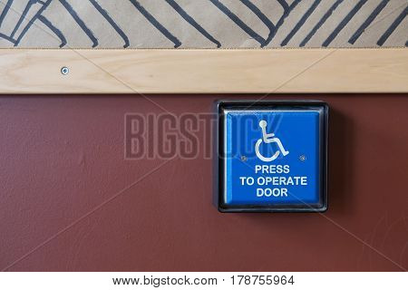 Handicapped Access Entrance Pad On A Wall.