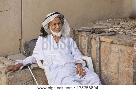 Nizwa Oma 24th March 2017: old Omani man selling old copper cooking dishes at the market