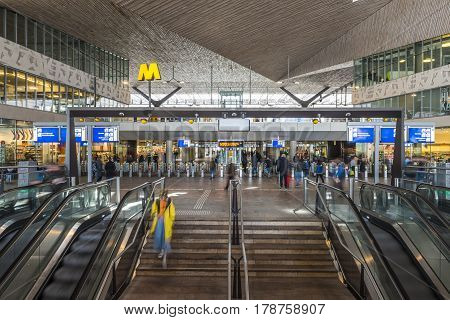 Rotterdam The Netherlands - March 10 2017: Interior of modern railway station by architect MVSA in Rotterdam with escalator stairs and travelers in the Netherlands.