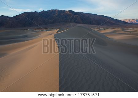 Waves Of Sand On Top Of The Dunes. Sunrise. Desert In Mesquite Flat, Death Valley, Usa.