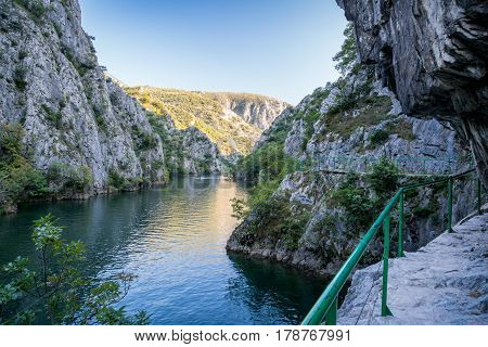 View of beautiful tourist attraction, lake at Matka Canyon in the Skopje surroundings, Macedonia. Hiking trail along side the mountain.