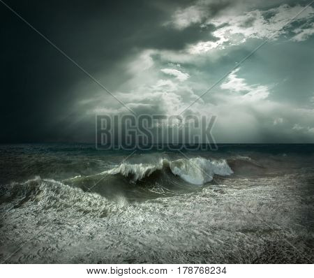 View of great storm on the sea. Strong wind and big waves with splash drops under dark sky.