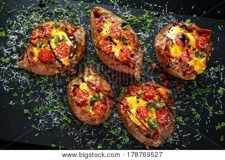 hot baked sweet potato stuffed with bacon, cheddar cheese, cherry tomatoes, balsamic vinegar, cress salad and parmesan sprinkle. Tacco, burrito style