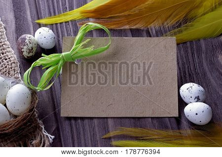 Easter Background With Easter Eggs Burlap Cloth Yellow Feathers Green Ribbon And Space For Text.