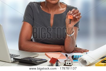 African-American realtor woman with key.