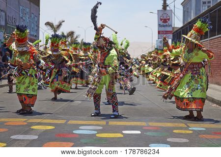 ARICA, CHILE - FEBRUARY 11, 2017: Tinkus Dance Group dressed in ornate costumes performing a Tinkus dance during a street parade at the annual Carnaval Andino con la Fuerza del Sol.