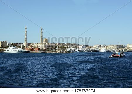Hurghada sea side view with great muslim mosque and port of modern yachts and boats