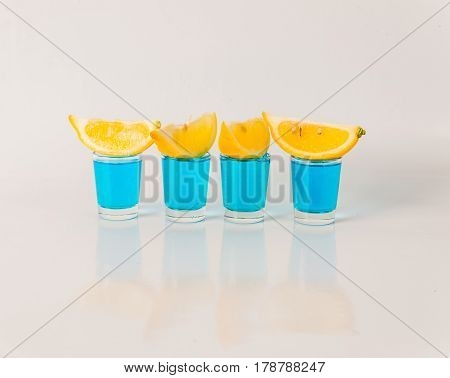 Four Glasses Of Blue Kamikaze, Glamorous Drink, Mixed Drink Poured Into Shot Glasses
