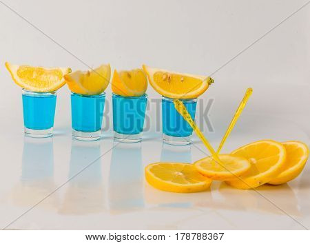 Four Glasses Of Blue Kamikaze, Glamorous Drink, Mixed Drink Poured Into Shot Glasses