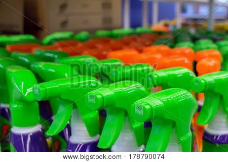 Close up of colorful spray bottles with cleaning agents in supermarket