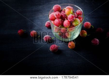 Frozen And Fresh Berries In A Glass Pial On A Black Background.