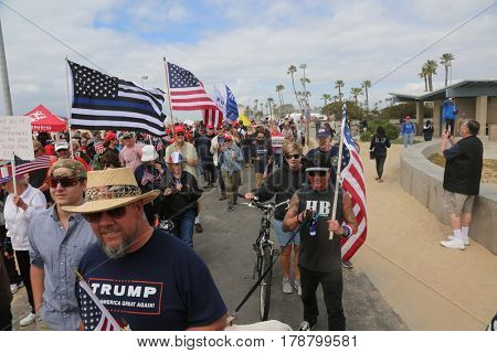 Huntington Beach, CA - March 25 2017: Make America Great Again March. Thousands of Supporters of republican president Donald Trump, wave flags, signs and march at a MAGA March in Huntington Beach. 

