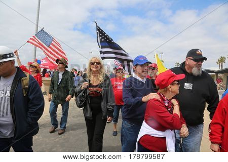 Huntington Beach, CA - March 25 2017: Make America Great Again March. Thousands of Supporters of republican president Donald Trump, wave flags, signs and march at a MAGA March in Huntington Beach. 

