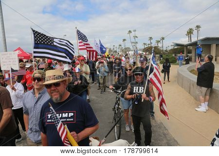 Huntington Beach, CA - March 25 2017: Make America Great Again March. Thousands of Supporters of republican president Donald Trump, wave flags, signs and march at a MAGA March in Huntington Beach. 

