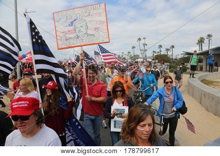 Huntington Beach, CA - March 25 2017: Make America Great Again March. Thousands of Supporters of republican president Donald Trump, wave flags, signs and march at a MAGA March in Huntington Beach. 

