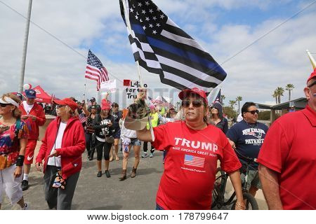 Huntington Beach, CA - March 25 2017: Make America Great Again March. Thousands of Supporters of republican president Donald Trump, wave flags, signs and march at a MAGA March in Huntington Beach. 

